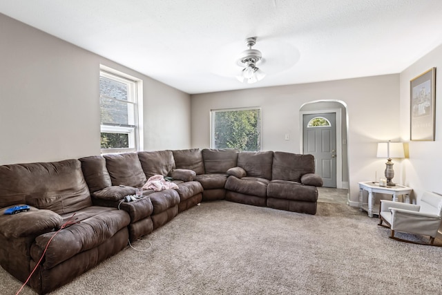 living room featuring carpet and ceiling fan