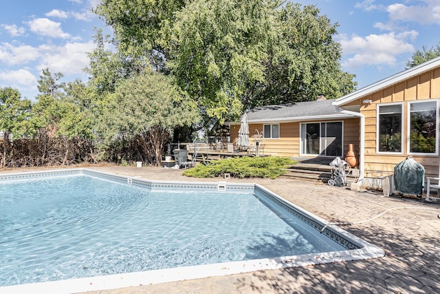 view of pool featuring a patio and a deck