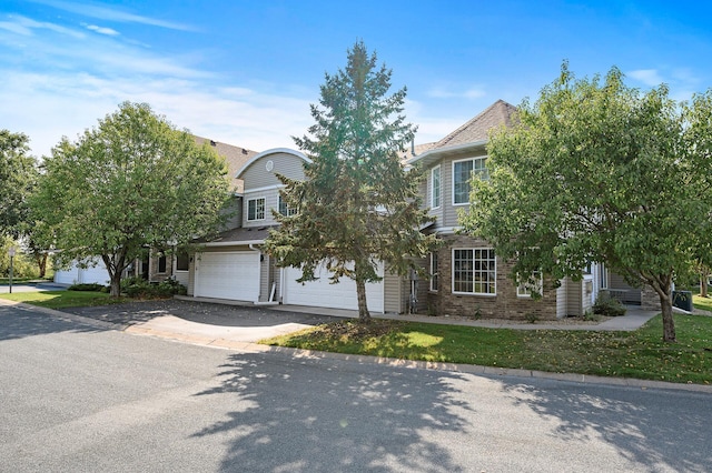 view of property hidden behind natural elements featuring a garage