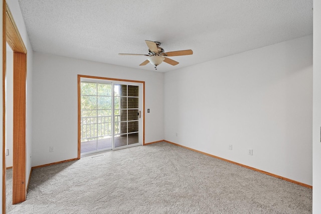 unfurnished room with ceiling fan, a textured ceiling, and light carpet