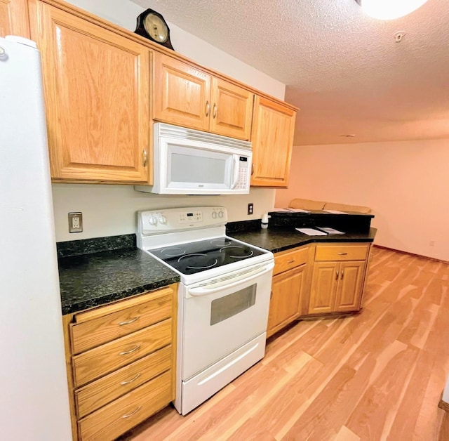 kitchen featuring light brown cabinetry, white appliances, light hardwood / wood-style flooring, and a textured ceiling