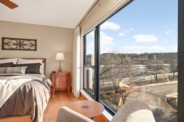 bedroom with ceiling fan and light hardwood / wood-style flooring