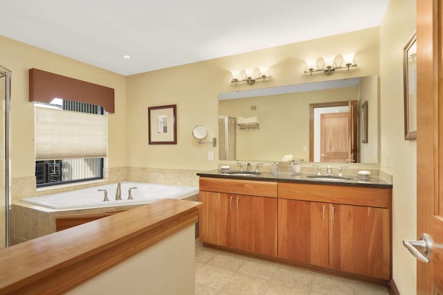 bathroom featuring vanity, tile patterned floors, and separate shower and tub