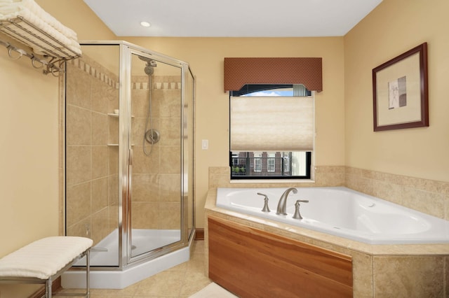 bathroom featuring tile patterned flooring and shower with separate bathtub