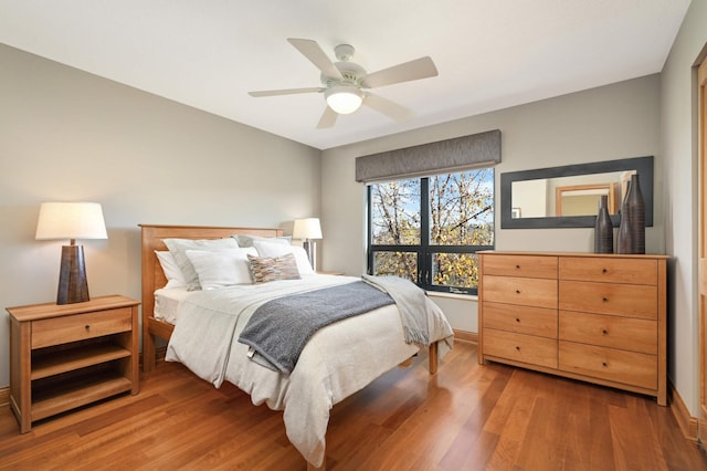 bedroom with ceiling fan and hardwood / wood-style floors