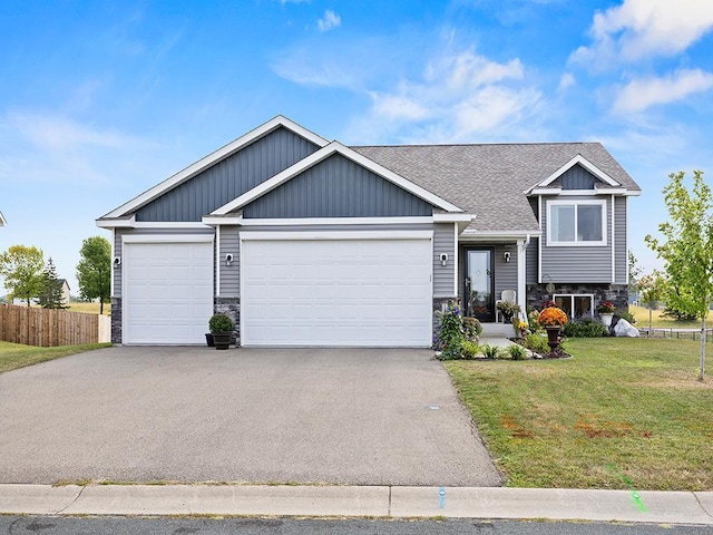 view of front of house with a front lawn and a garage