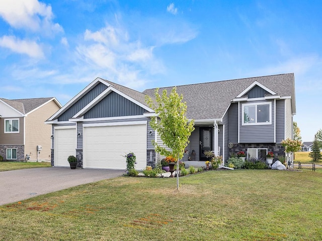 view of front of house featuring a garage and a front lawn