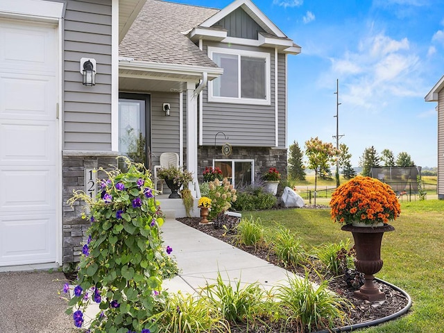 entrance to property with a lawn