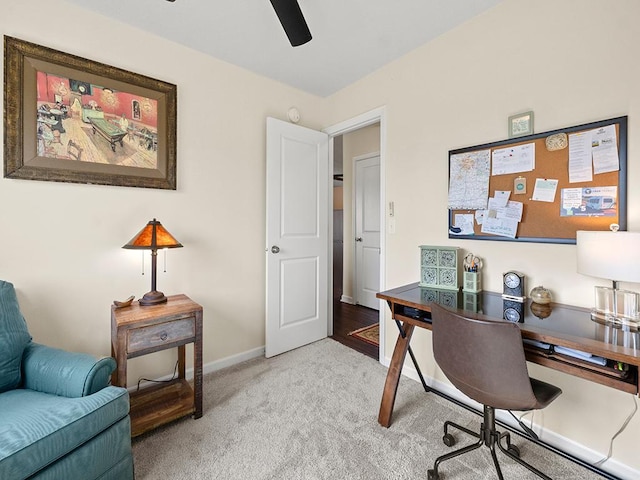 carpeted office space featuring ceiling fan