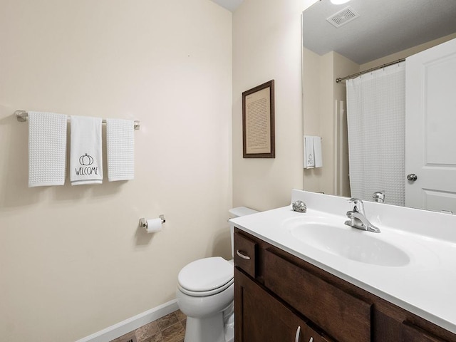 bathroom featuring tile patterned floors, vanity, and toilet