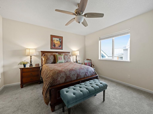 carpeted bedroom featuring a textured ceiling and ceiling fan