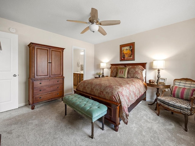 carpeted bedroom with ceiling fan and connected bathroom