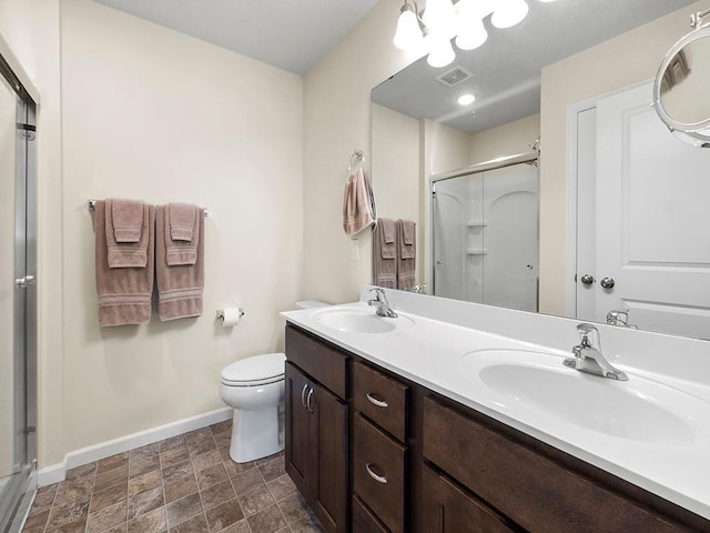 bathroom featuring an enclosed shower, toilet, and vanity