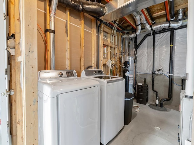 laundry area featuring water heater and separate washer and dryer