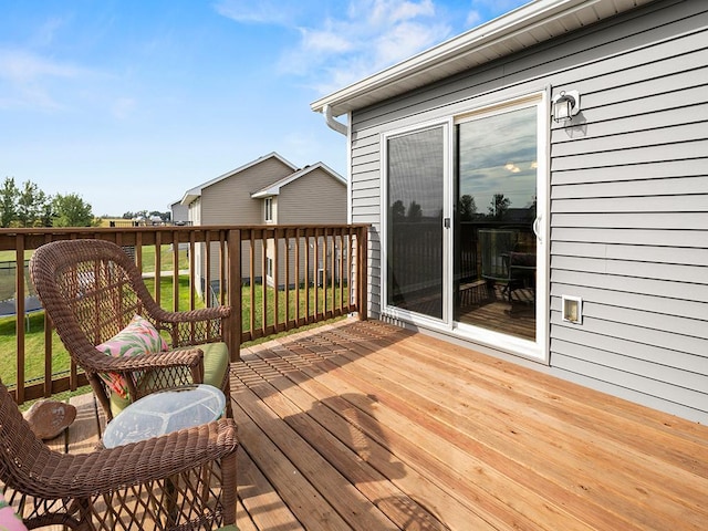 wooden terrace with a yard