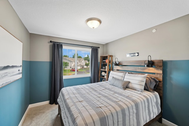 bedroom with a textured ceiling and carpet floors