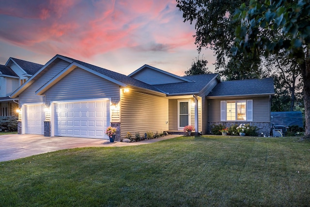 view of front of property featuring a garage and a yard