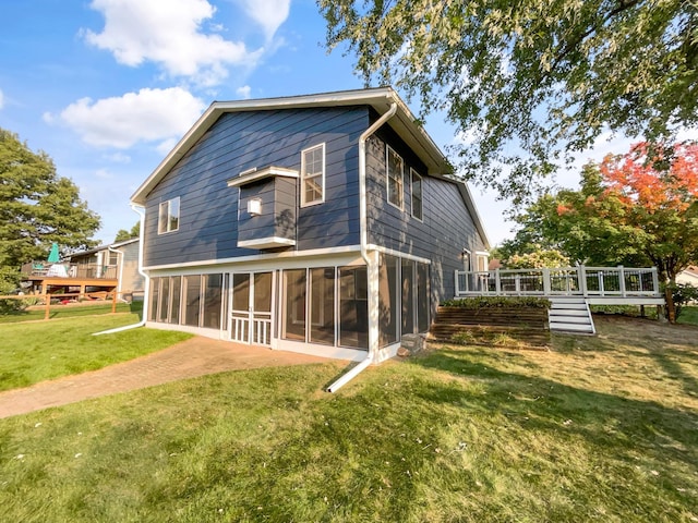 back of property with a sunroom and a yard