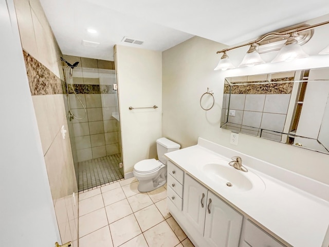 bathroom with tile patterned flooring, vanity, toilet, and a shower with door