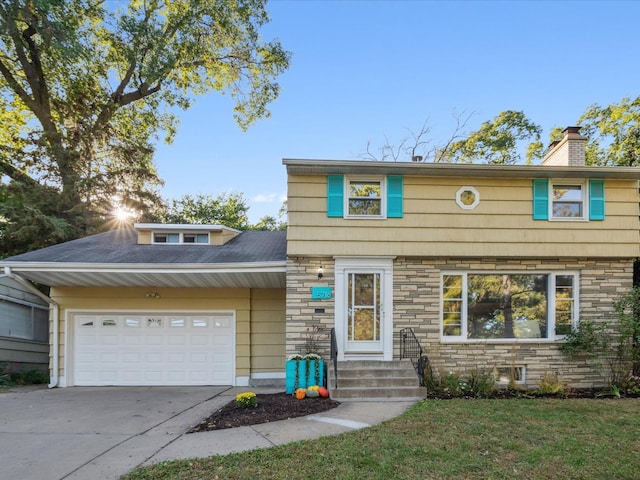 view of front of house featuring a front yard and a garage