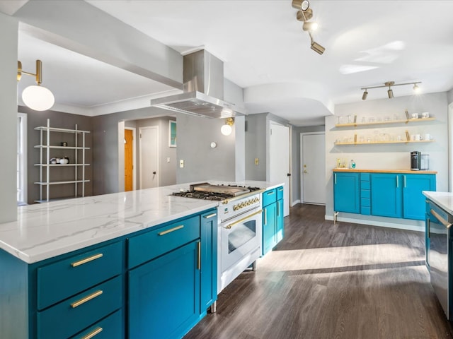 kitchen with blue cabinetry, dark hardwood / wood-style floors, high end stove, and exhaust hood