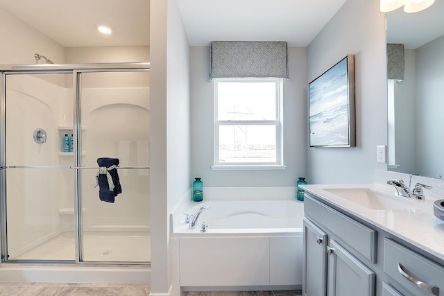 bathroom with vanity and independent shower and bath