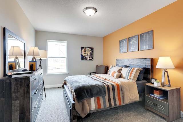 bedroom with dark carpet and a textured ceiling