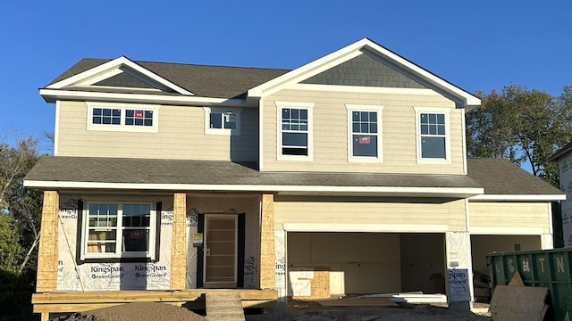 view of front of home featuring covered porch and a garage