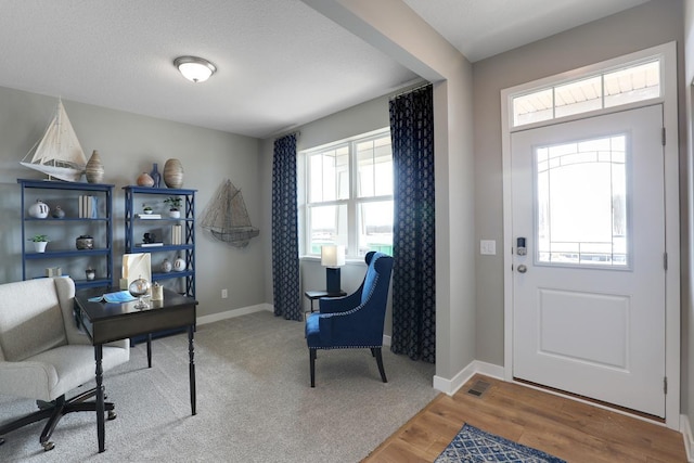 home office featuring hardwood / wood-style floors and a textured ceiling