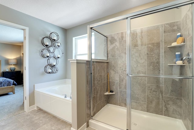 bathroom featuring a textured ceiling, plus walk in shower, and tile patterned floors