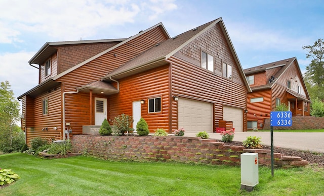 view of home's exterior featuring a yard and a garage