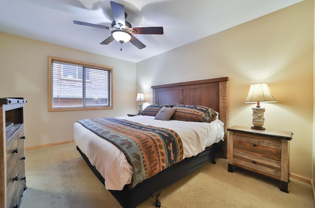 bedroom with ceiling fan and light carpet