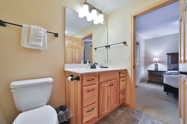 bathroom with tile patterned flooring, vanity, and toilet