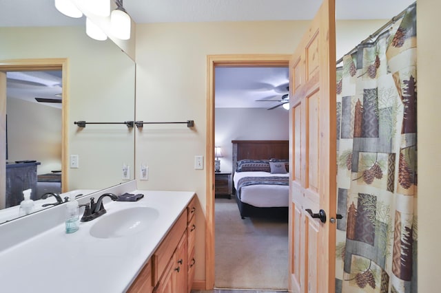 bathroom with a shower with curtain, ceiling fan, and vanity