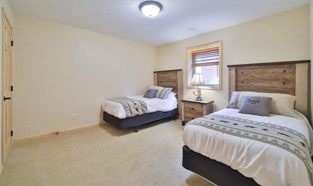 carpeted bedroom featuring a textured ceiling