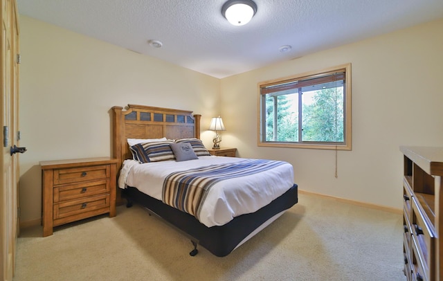 carpeted bedroom featuring a textured ceiling