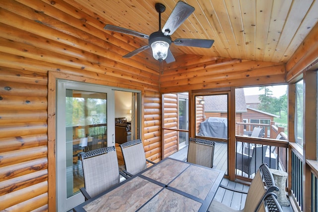 unfurnished sunroom featuring wood ceiling, vaulted ceiling, and ceiling fan