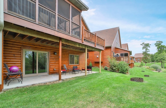 rear view of property with a lawn, a patio, and a deck