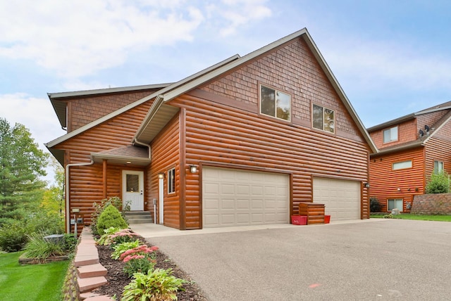 6334 Wilderness Rd Unit 31, Pequot Lakes, MN 56472 - rustic home with an attached garage, log veneer siding, and aphalt driveway