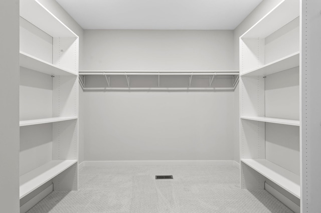 spacious closet featuring visible vents and carpet flooring