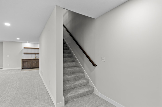 stairs featuring carpet, baseboards, and recessed lighting