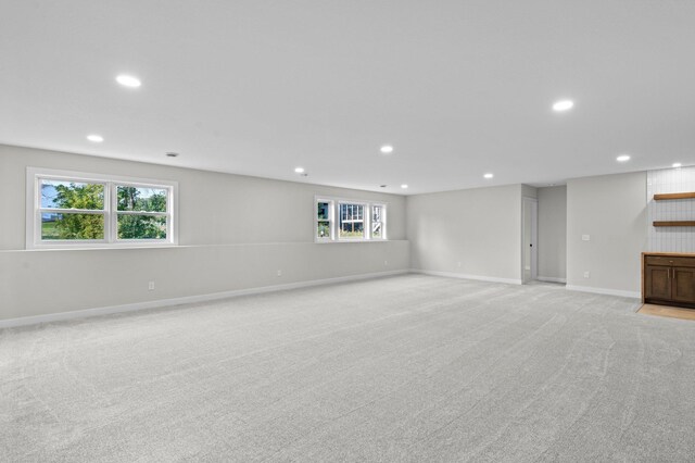 interior space with recessed lighting, light colored carpet, and baseboards