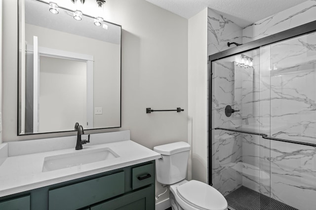 full bath with toilet, vanity, a marble finish shower, and a textured ceiling