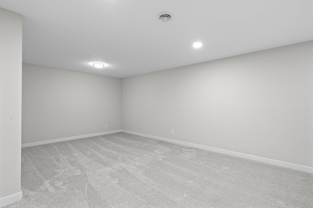 carpeted empty room featuring recessed lighting, visible vents, and baseboards