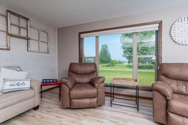 living area featuring light wood-style flooring and baseboards