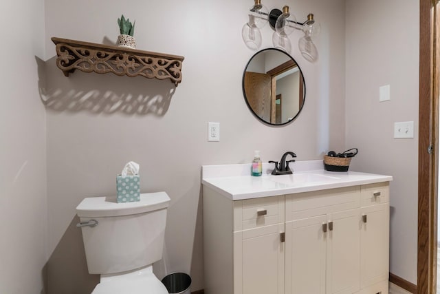 bathroom featuring toilet and vanity