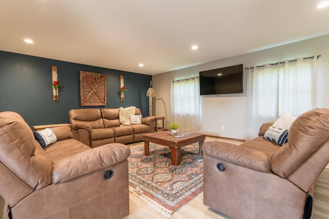 living area featuring recessed lighting, baseboards, and light wood finished floors