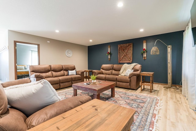 living area featuring recessed lighting, baseboards, and light wood-style floors