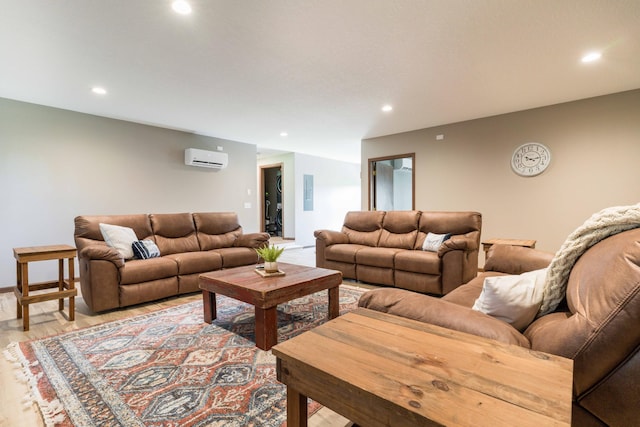 living room featuring an AC wall unit, recessed lighting, and light wood-type flooring