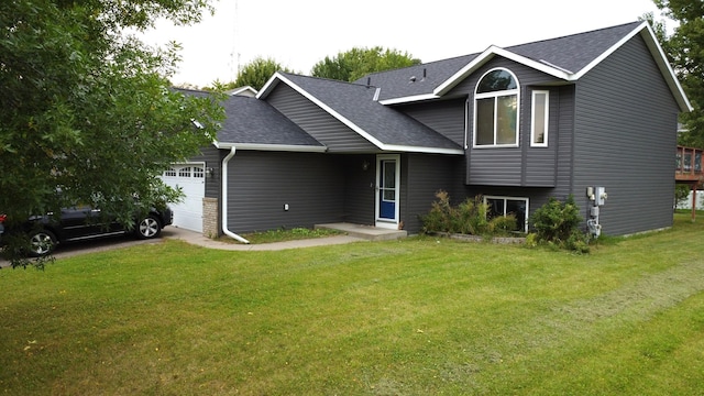 view of front of home with a front yard and a garage